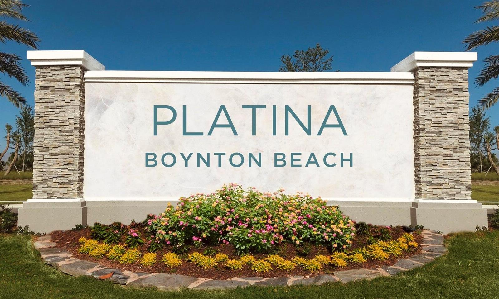 A stone and stucco monument sign for Platina in Boynton Beach sits in a garden — 5418 Firenze Drive # P, Boynton Beach FL 33437, BOYNTON BEACH, FL