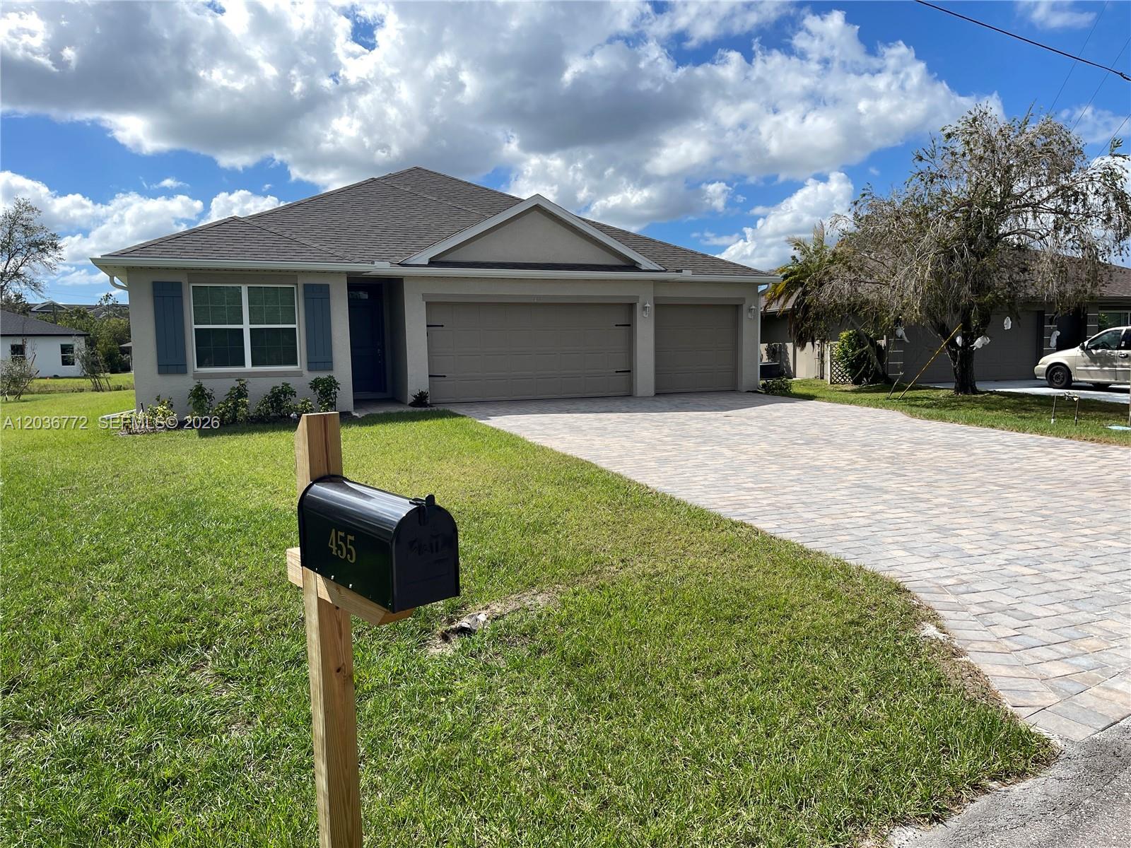 A single-story house with a paved driveway, a two-car garage, and a mailbox in front — 455 Londrina Dr, Punta Gorda FL 33983, PUNTA GORDA, FL