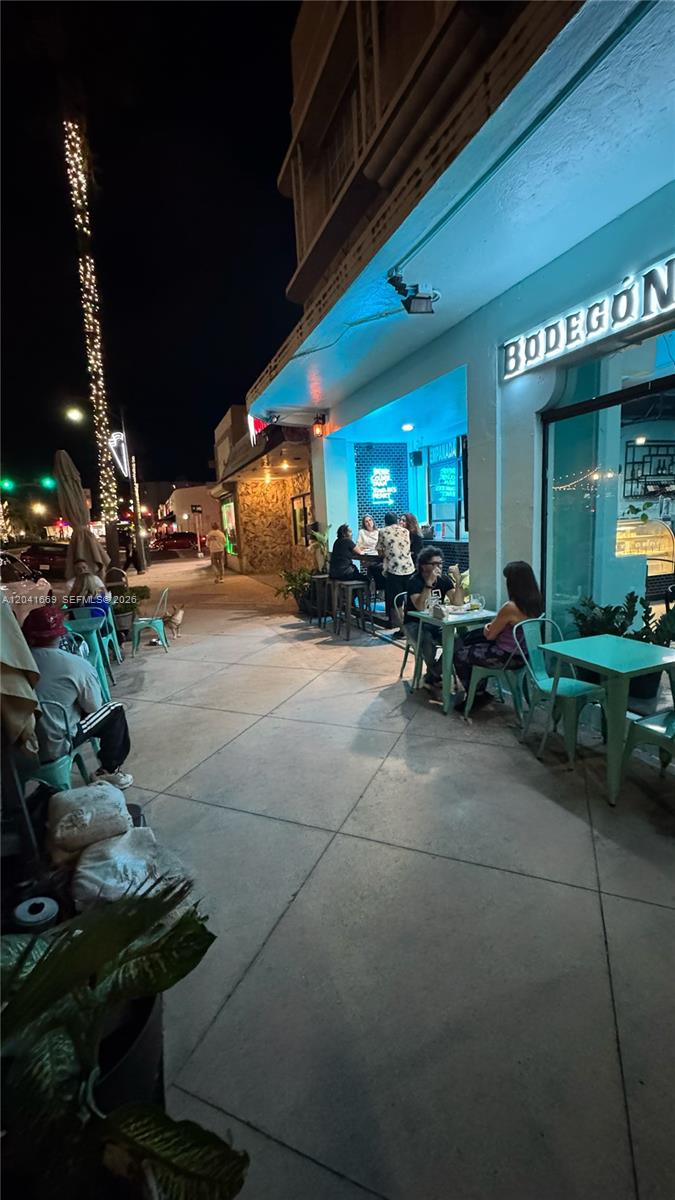 An outdoor sidewalk dining area at night features tables and chairs outside a restaurant — 1014 71st St, Miami Beach FL 33141, MIAMI BEACH, FL