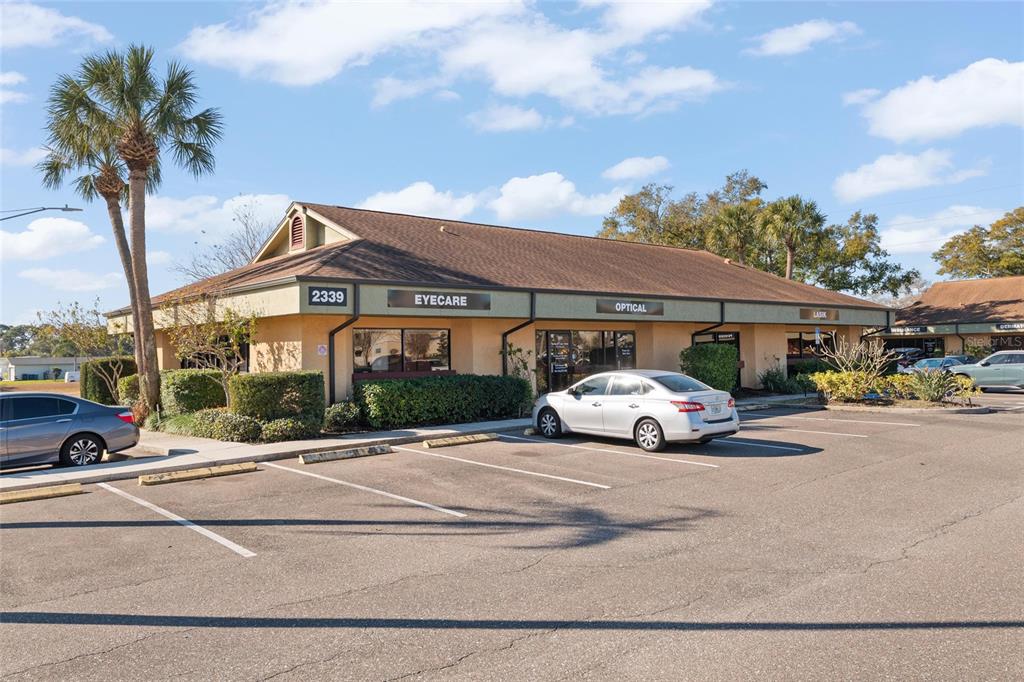A single-story commercial building with an eyecare and optical office features a parking lot — 2339 SUNSET POINT ROAD UNIT C300-C302, CLEARWATER, FL