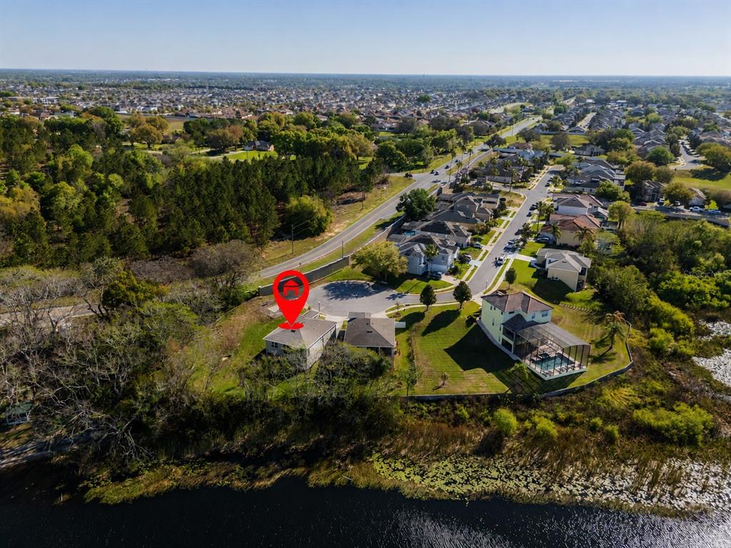 An aerial view shows a house with a red location pin near a lake — 358 CHEROKEE AVENUE, HAINES CITY, FL