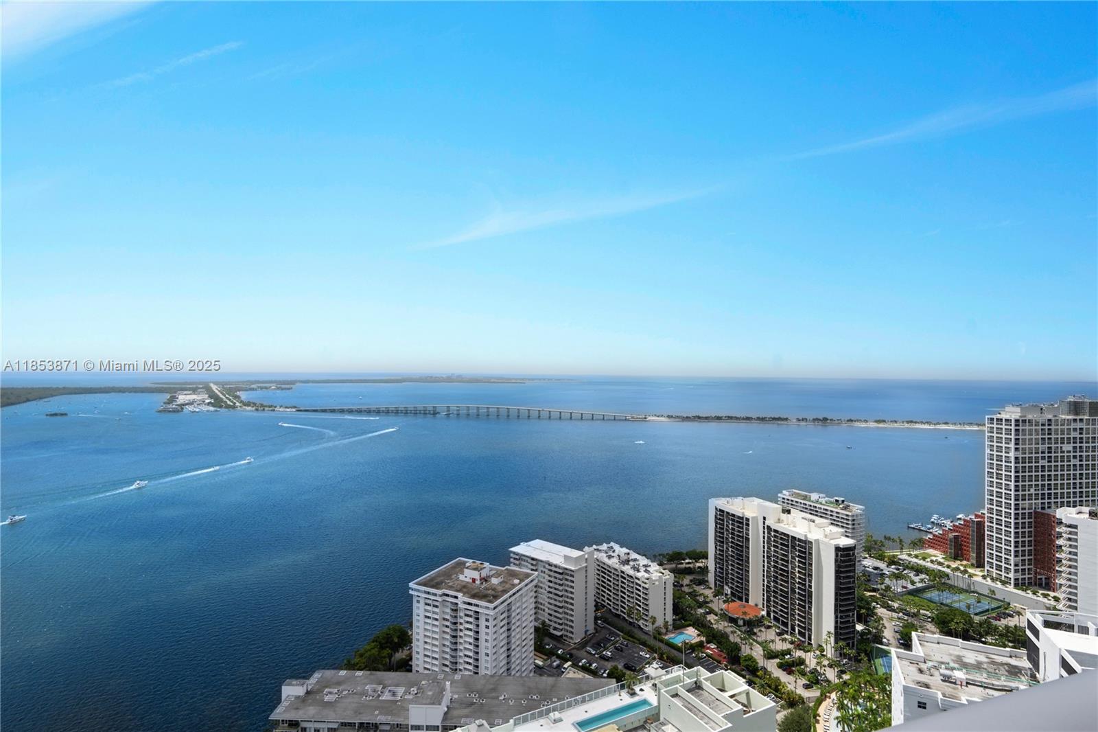 An aerial view shows high-rise buildings overlooking a large bay and a long bridge — 1300 Brickell Bay Dr # 4401, Miami FL 33131, MIAMI, FL