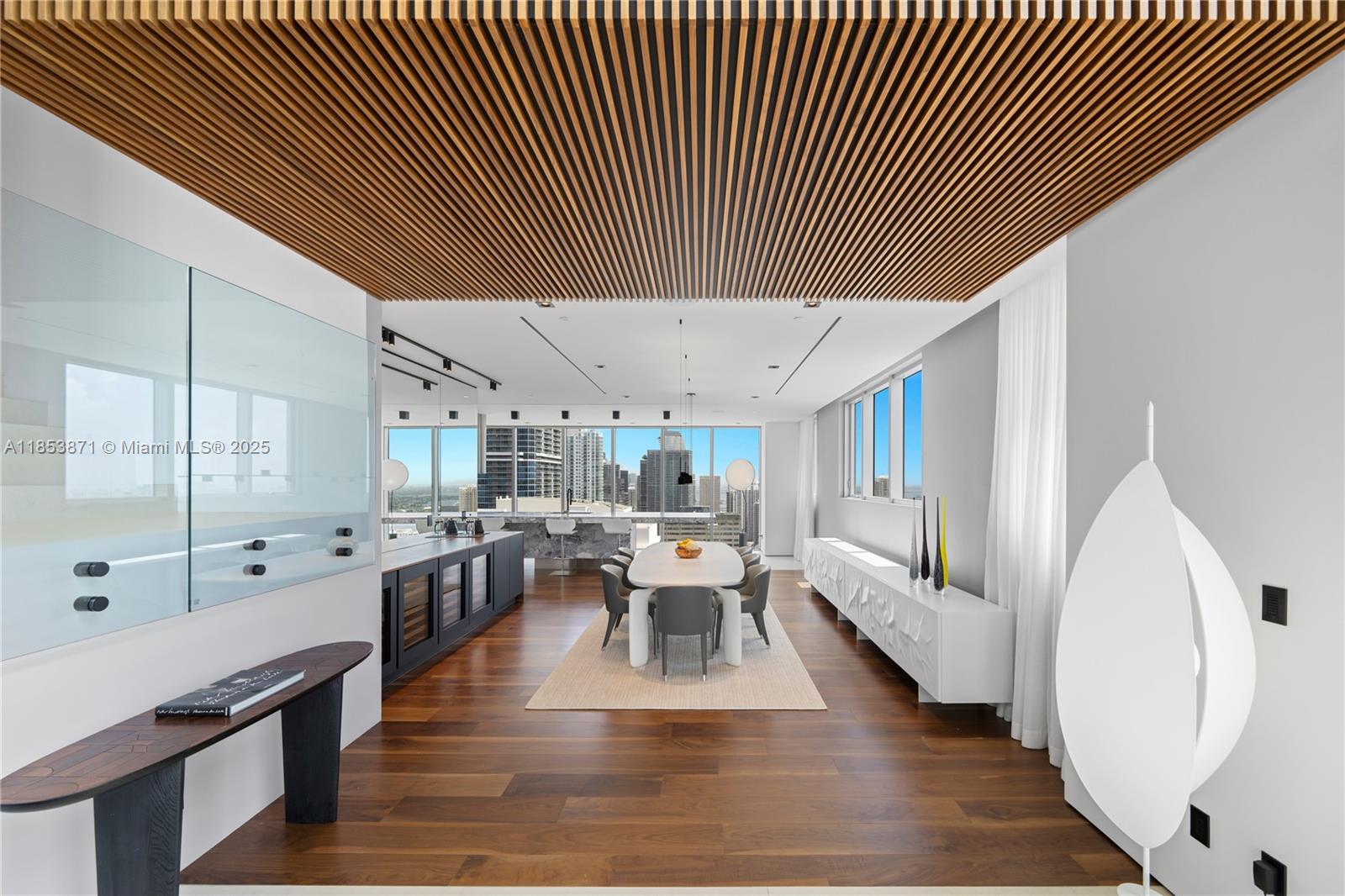 A modern dining room features a slatted wood ceiling, dark wood floors, and city views — 1300 Brickell Bay Dr # 4401, Miami FL 33131, MIAMI, FL
