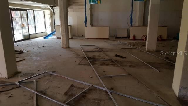 An interior view of a vacant, unfinished commercial space with exposed metal ceiling grid frames — Gautier Benitez INT. JIMENEZ SICARDO, CAGUAS, PR