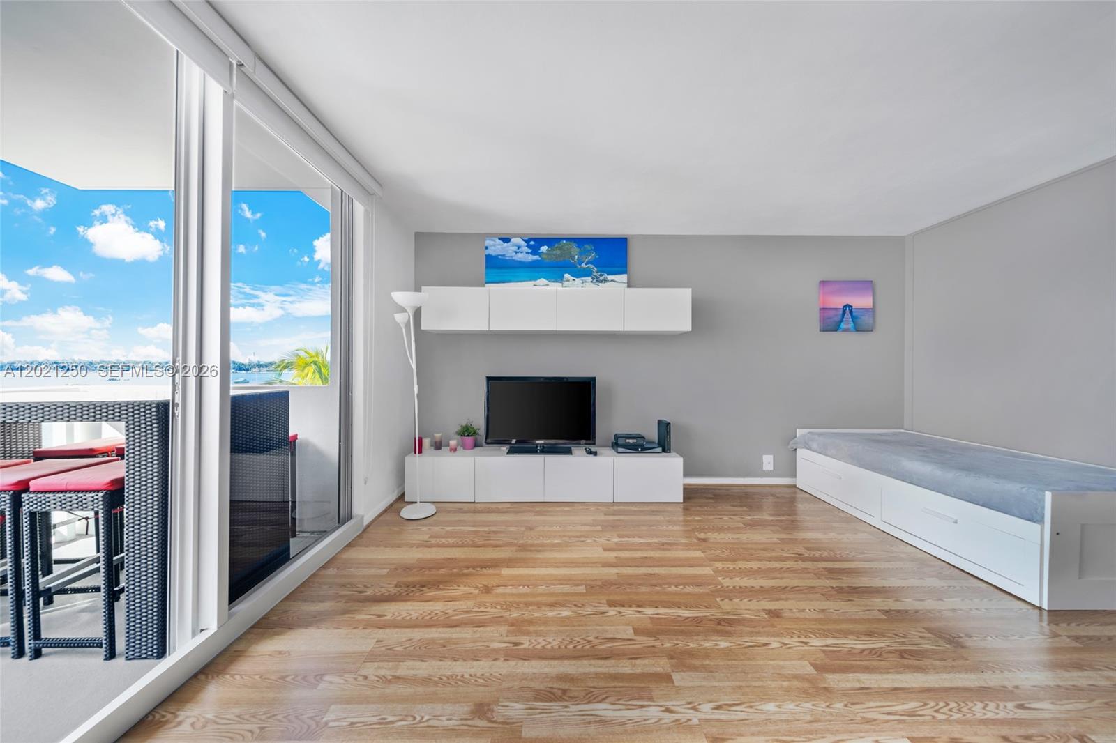 A living room features light wood floors, a white media console, and a daybed — 1200 West Ave # 327, Miami Beach FL 33139, MIAMI BEACH, FL