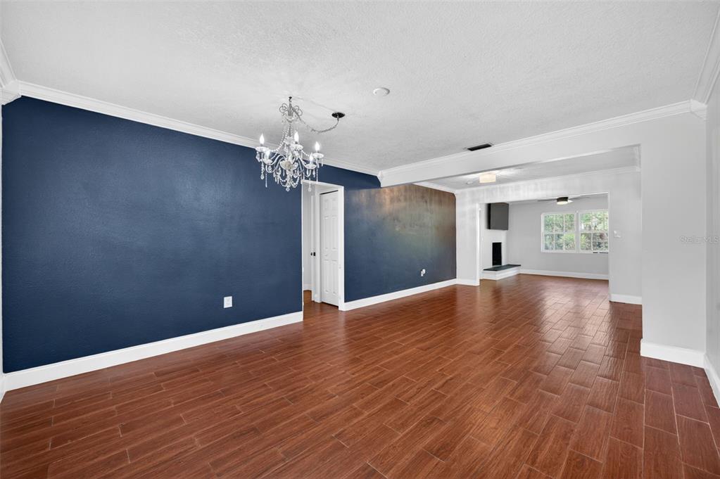 An interior view of a room with dark blue accent walls and wood-look tile flooring — 1009 LAKE BELL DRIVE, WINTER PARK, FL
