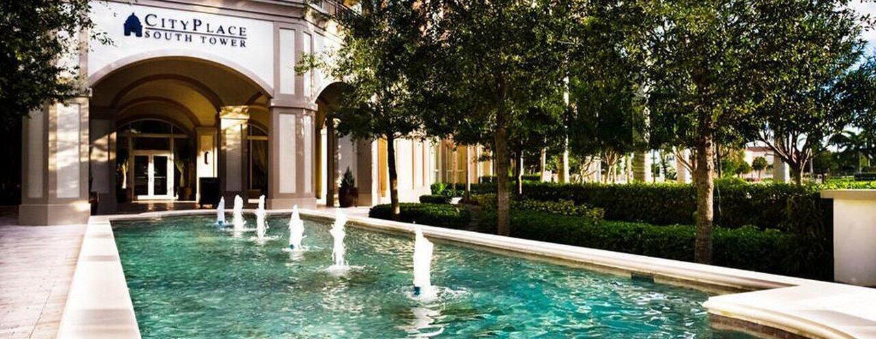 A fountain with multiple jets sits in front of the CityPlace South Tower building entrance — 550 Okeechobee Boulevard # 604, West Palm Beach FL 33401, WEST PALM BEACH, FL