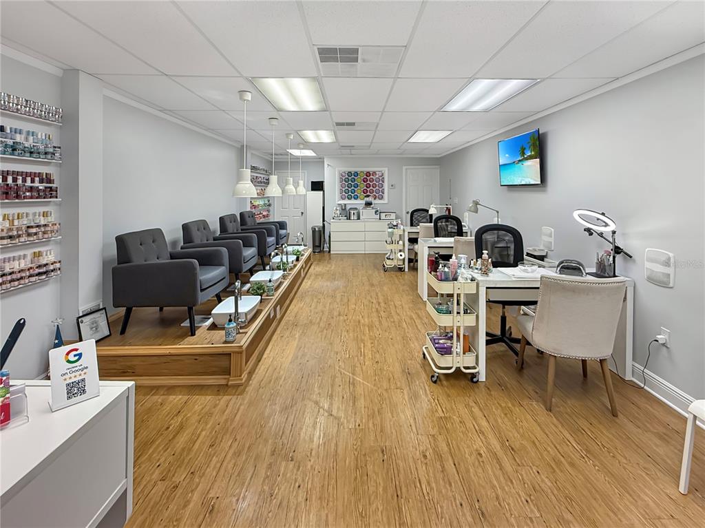 A nail salon features pedicure chairs on a raised platform and manicure stations with chairs — 11301 S ORANGE BLOSSOM TRAIL UNIT 204, ORLANDO, FL