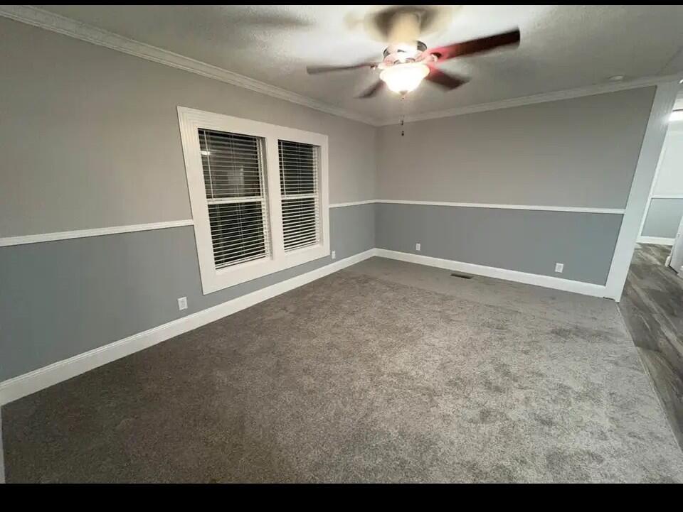 An empty bedroom features gray two-tone walls with white chair rail molding and carpeted flooring — 76 Sandhill Boulevard, Fort Pierce FL 34982, FORT PIERCE, FL
