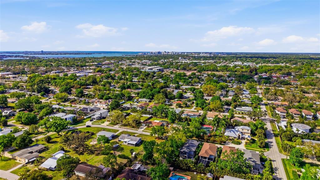 An aerial view shows a vacant, rectangular residential lot outlined in white within a neighborhood — 2320 FLORINDA STREET, SARASOTA, FL