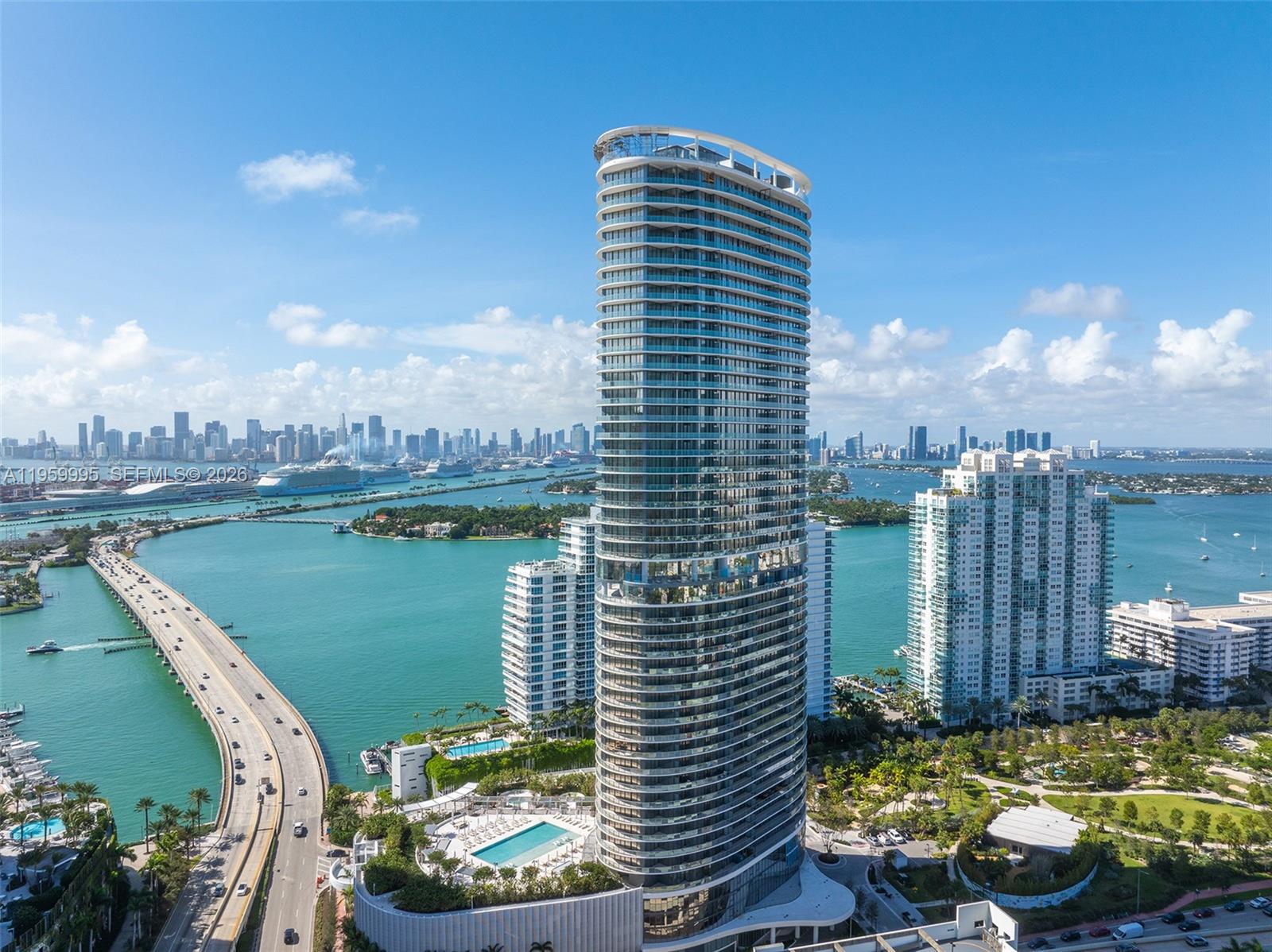 A balcony with modern seating overlooks a city skyline and water at twilight — 500 Alton Rd # 2903, Miami Beach FL 33139, MIAMI BEACH, FL