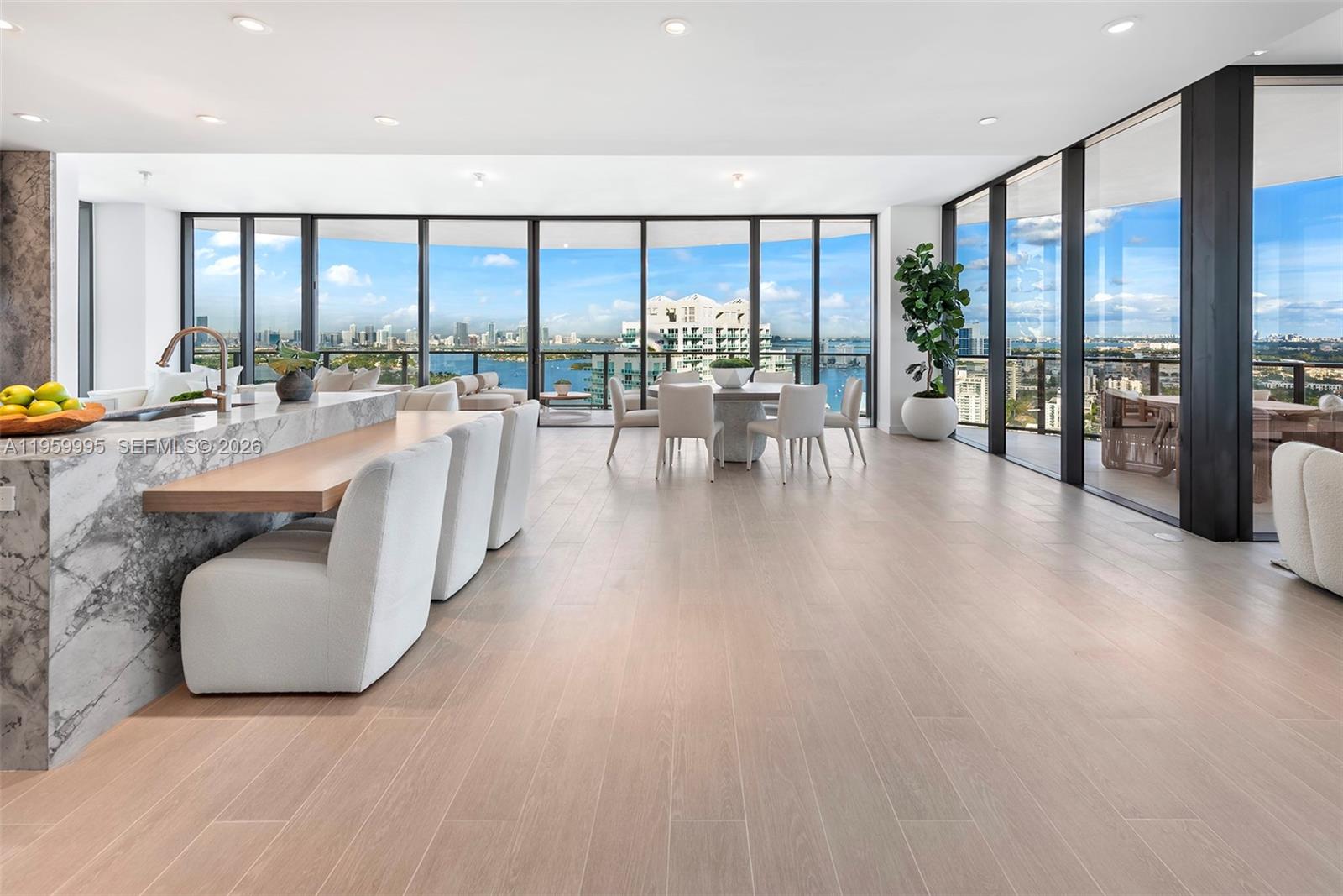 A bedroom features a bed, a pendant light, and floor-to-ceiling windows overlooking a city skyline — 500 Alton Rd # 2903, Miami Beach FL 33139, MIAMI BEACH, FL