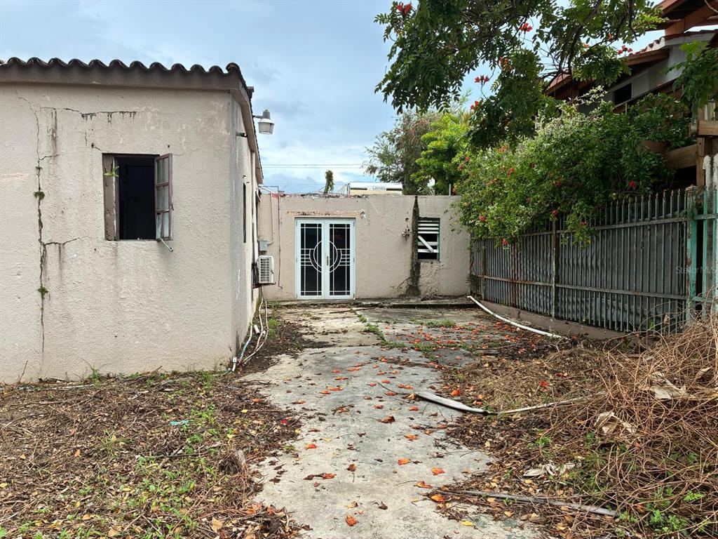 A concrete patio area sits between two exterior walls with a set of French doors — 58 CALLE TENIENTE MATTA, SAN JUAN, PR