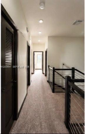 A carpeted hallway leads to a doorway with a dark railing overlooking the stairs — 15668 NW 91st Ct, Miami Lakes FL 33018, MIAMI LAKES, FL