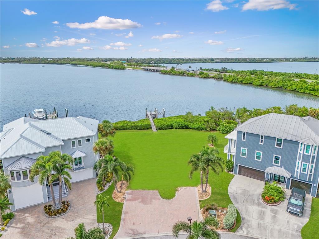 An aerial view shows two houses separated by a large lawn leading to a private dock — 5539 2ND AVENUE CIRCLE W, PALMETTO, FL