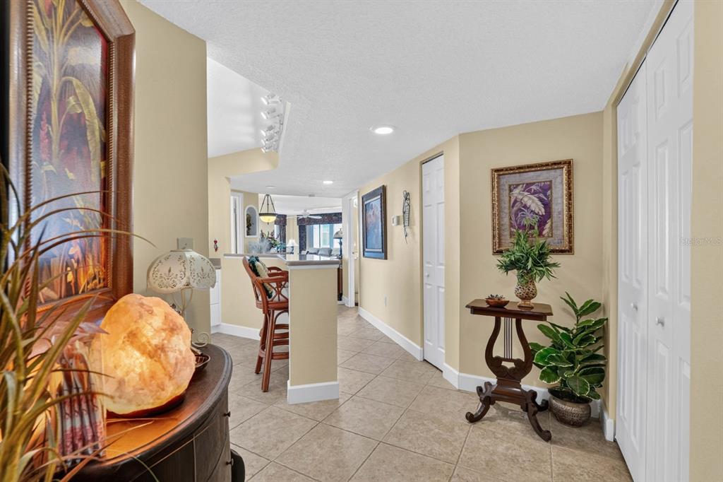 A tiled entryway leads to a kitchen with a breakfast bar and living area beyond — 925 N HALIFAX AVENUE UNIT 403, DAYTONA BEACH, FL