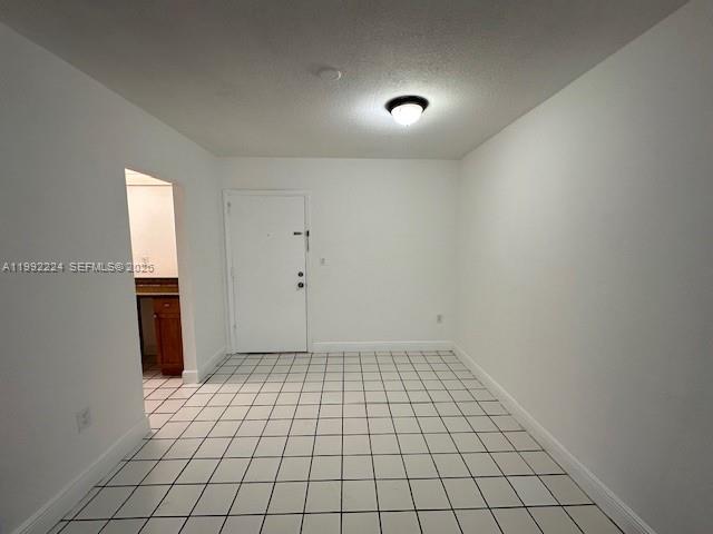 A room with white walls, a white door, and white tiled flooring with dark grout — 5400 SW 77 Court # 2R, Miami FL 33155, MIAMI, FL