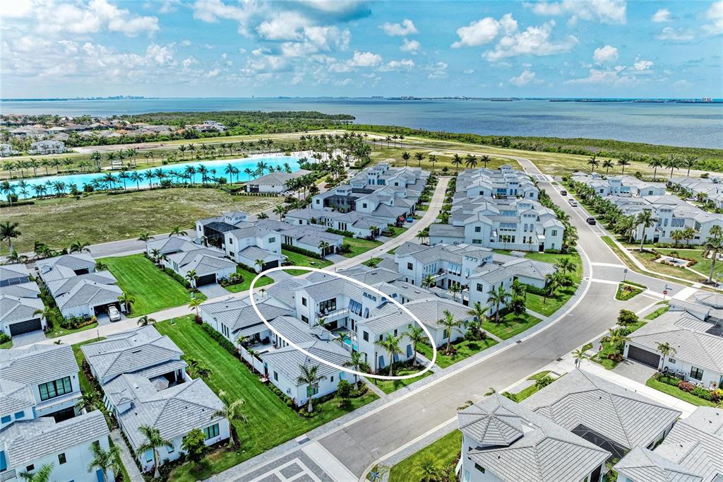 An aerial view shows a two-story residential home with a private pool and courtyard — 5935 CAT CLAW LANE, BRADENTON, FL