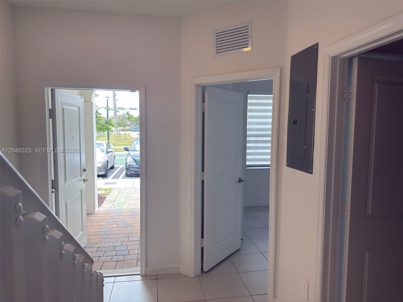 An entryway features a front door, an interior doorway, and a wall-mounted electrical panel — HOMESTEAD, FL