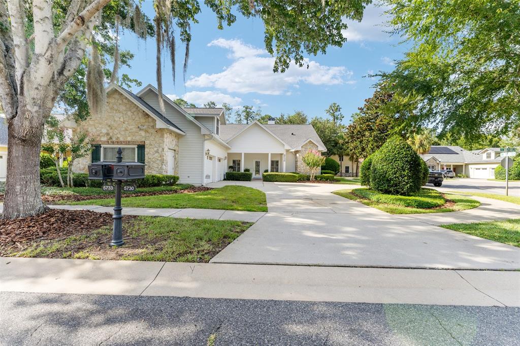 A stone and siding house with a concrete driveway and a dual mailbox in front — 5730 NW 52ND PLACE, GAINESVILLE, FL