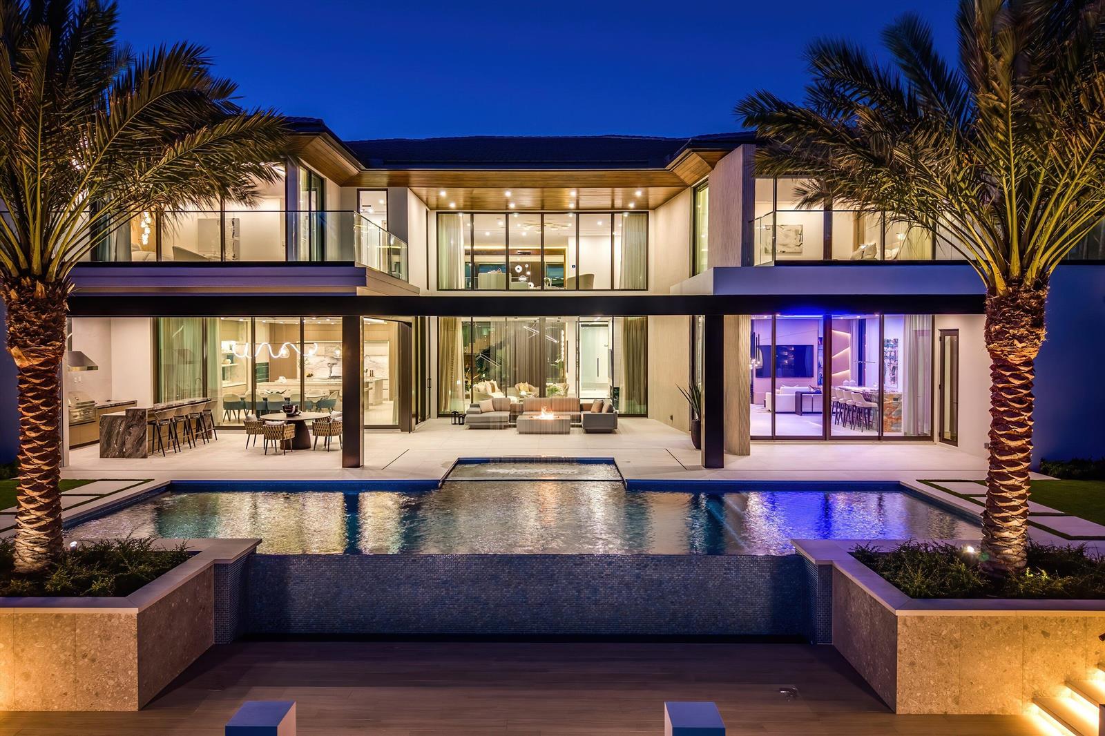 A modern two-story house with a pool, palm trees, and an illuminated outdoor patio area — 234 W Alexander Palm Road, Boca Raton FL 33432, BOCA RATON, FL