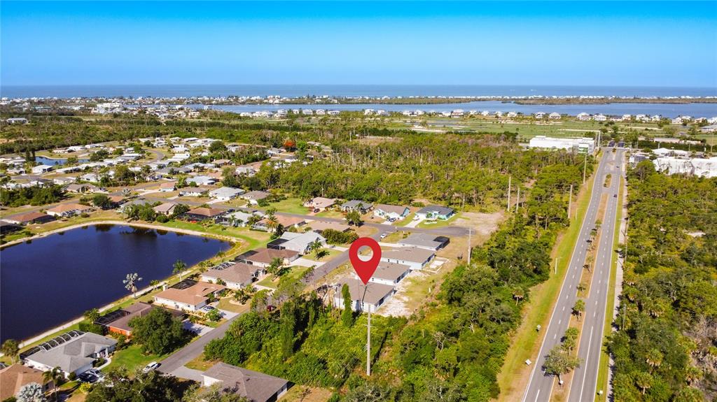 An aerial view shows a residential neighborhood with a red location pin over a house — 9040 EVELYN ROAD, ENGLEWOOD, FL
