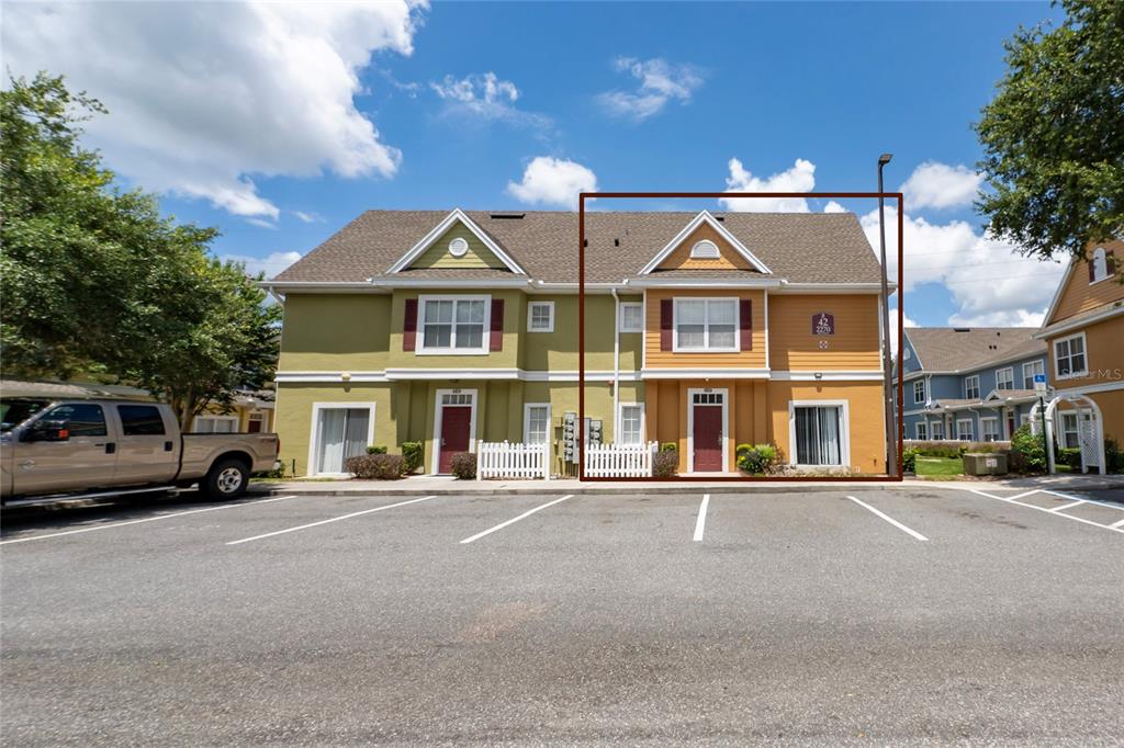 A two-story orange townhouse unit with a gabled roof and a front entrance — 2270 SAN VITAL DRIVE UNIT 107, KISSIMMEE, FL