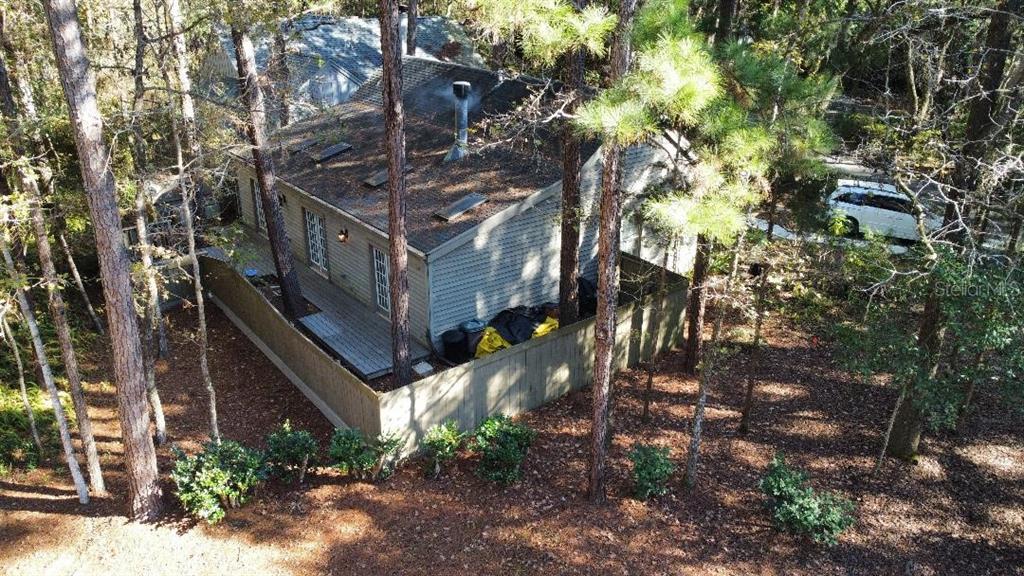 An elevated view shows a single-story house with a screened porch and landscaped yard — 5201 SW 86 TERRACE, GAINESVILLE, FL