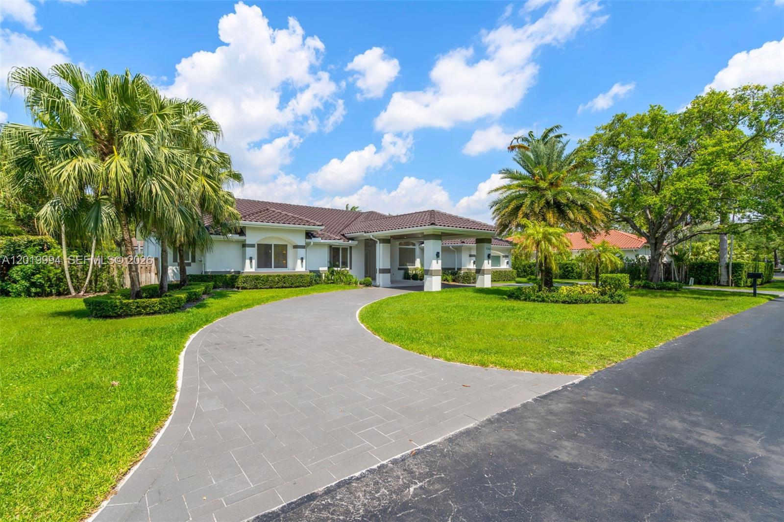 A single-story house with a tiled roof and a paved driveway sits on a lawn — 7262 SW 120th Ave, Miami FL 33183, MIAMI, FL