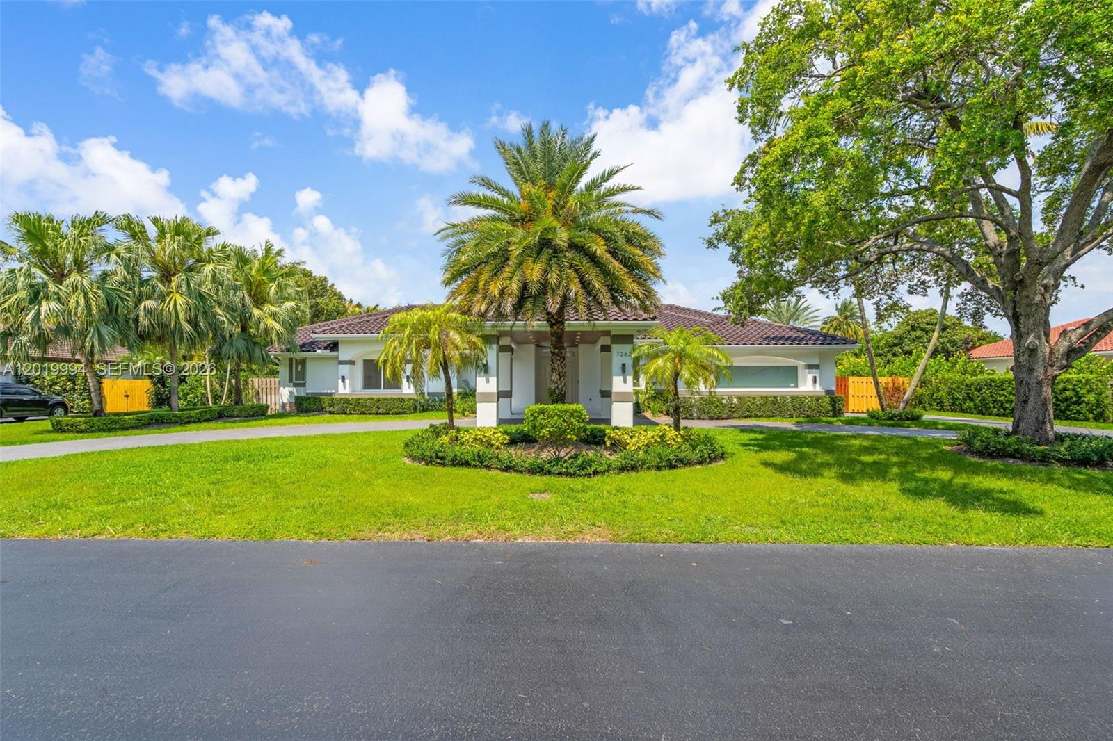 A single-story house with a tiled roof, palm trees, and a circular driveway — 7262 SW 120th Ave, Miami FL 33183, MIAMI, FL