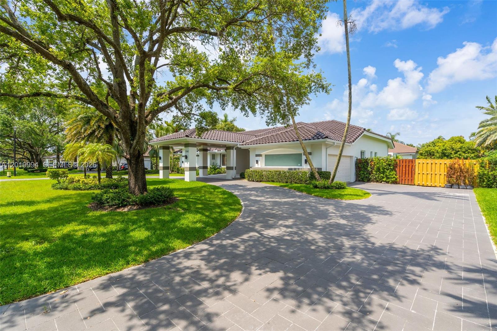 A single-story house with a tiled roof, a porte-cochère, and a large paved driveway — 7262 SW 120th Ave, Miami FL 33183, MIAMI, FL