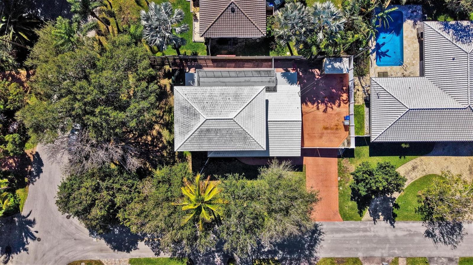 An aerial view shows a house with a gray roof, a pool, and surrounding trees — 2780 SE 5th Court, Pompano Beach FL 33062, POMPANO BEACH, FL