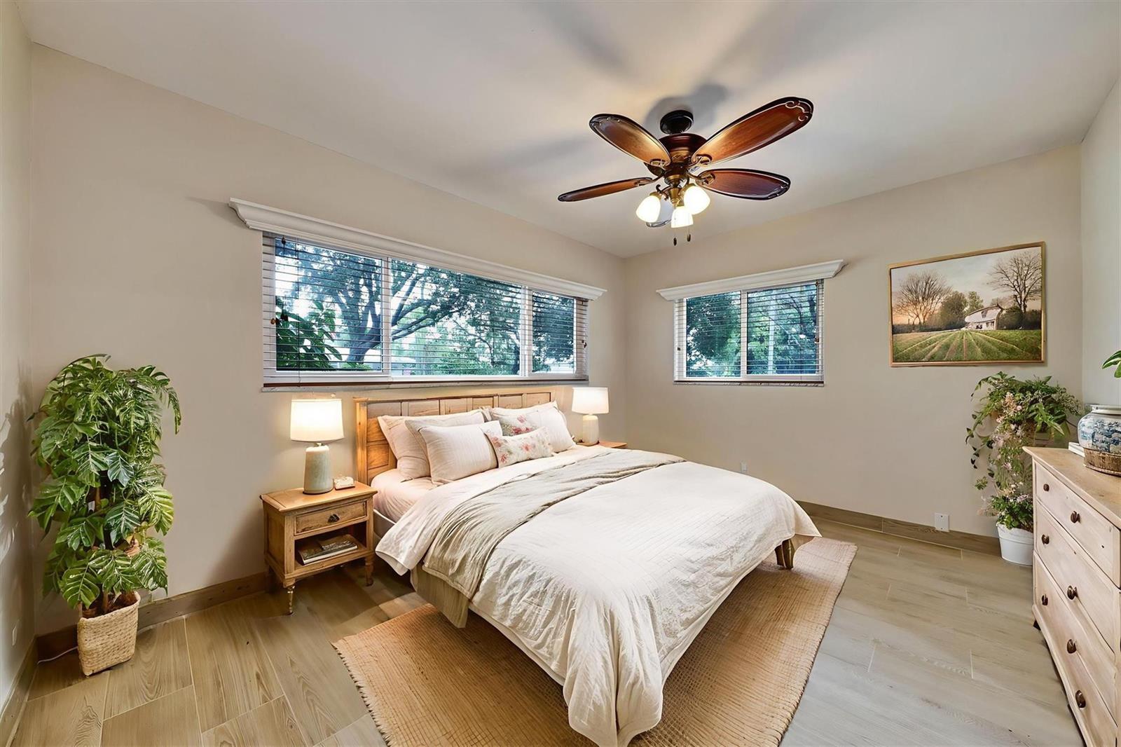A bedroom features a bed, two nightstands, a dresser, a ceiling fan, and two windows — 2780 SE 5th Court, Pompano Beach FL 33062, POMPANO BEACH, FL
