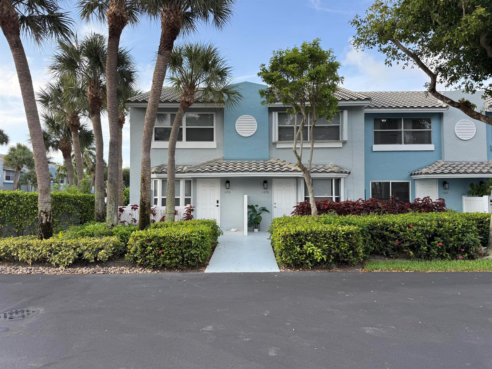 A two-story residential building features blue and grey siding with palm trees and landscaping — 1078 Jeffery Street, Boca Raton FL 33487, BOCA RATON, FL