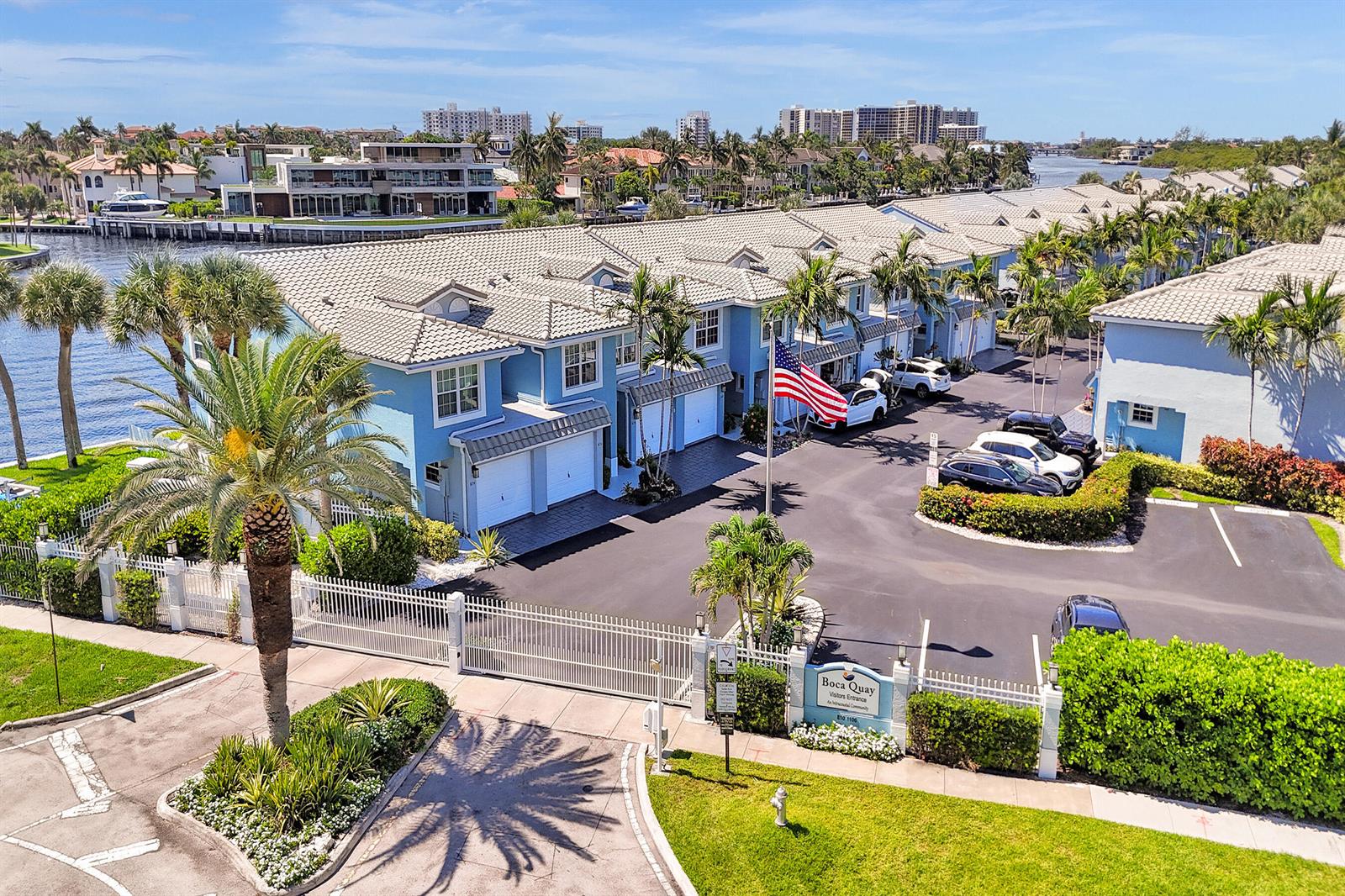 An aerial view shows a blue multi-unit residential complex with a gated entrance and canal — 1078 Jeffery Street, Boca Raton FL 33487, BOCA RATON, FL