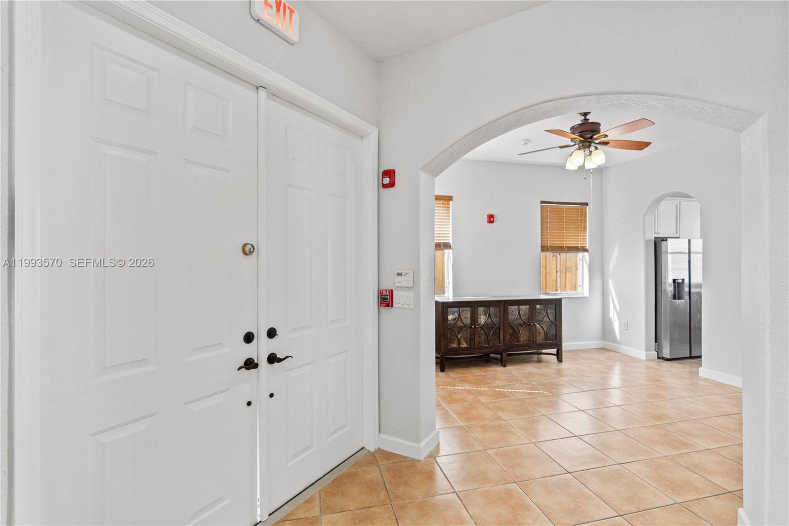 A white double-door entryway leads into a tiled room with an arched opening — 18140 NW 90th Ave, Hialeah FL 33018, HIALEAH, FL