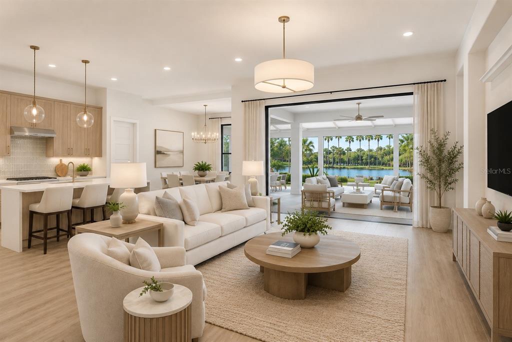 A bright living room with light wood floors, a white sofa, and a large sliding door — 14222 MAYSVILLE CIRCLE, PORT CHARLOTTE, FL