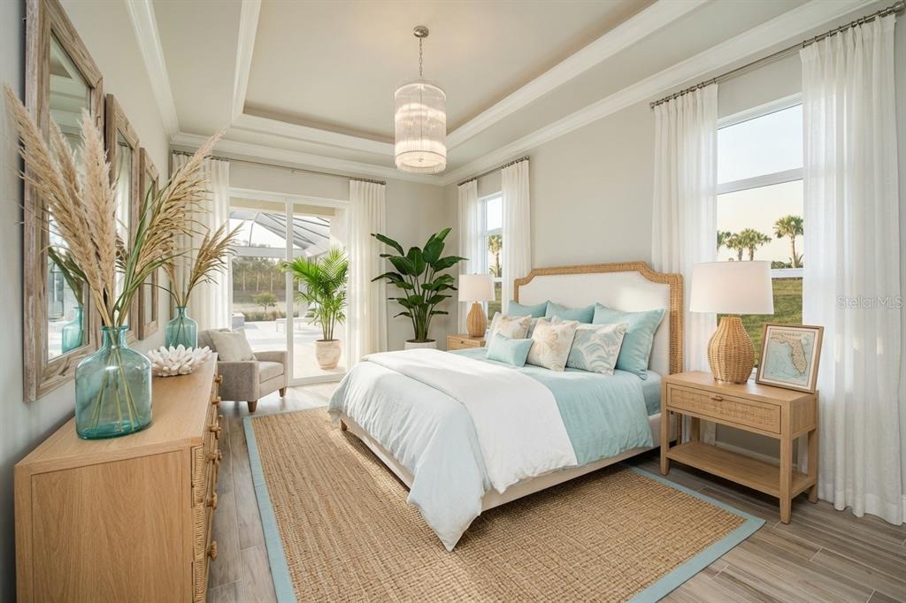A bright bedroom features a queen bed, light wood furniture, a jute rug, and patio access — 14222 MAYSVILLE CIRCLE, PORT CHARLOTTE, FL