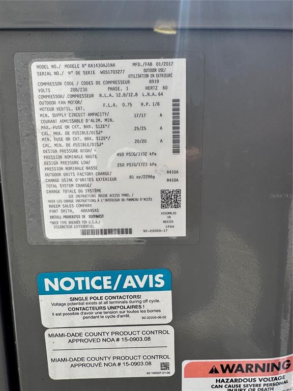 A close-up view of an HVAC unit data plate showing technical specifications and safety warnings — 5754 PARKVIEW LAKE DRIVE, ORLANDO, FL