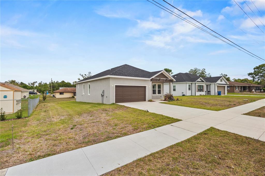 A single-story house with a brown garage door and a concrete driveway — 9211 NORTHCLIFFE BOULEVARD, SPRING HILL, FL