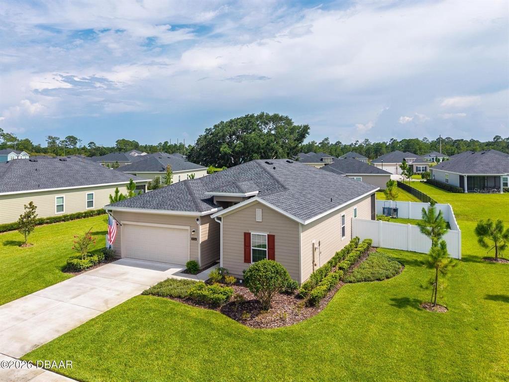 An aerial view shows a tan single-story house with a gray roof and attached garage — 4116 ACOMA DRIVE, ORMOND BEACH, FL