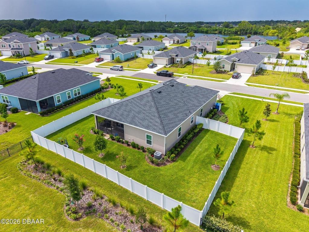 An aerial view shows a suburban house with a fenced backyard and a screened porch — 4116 ACOMA DRIVE, ORMOND BEACH, FL