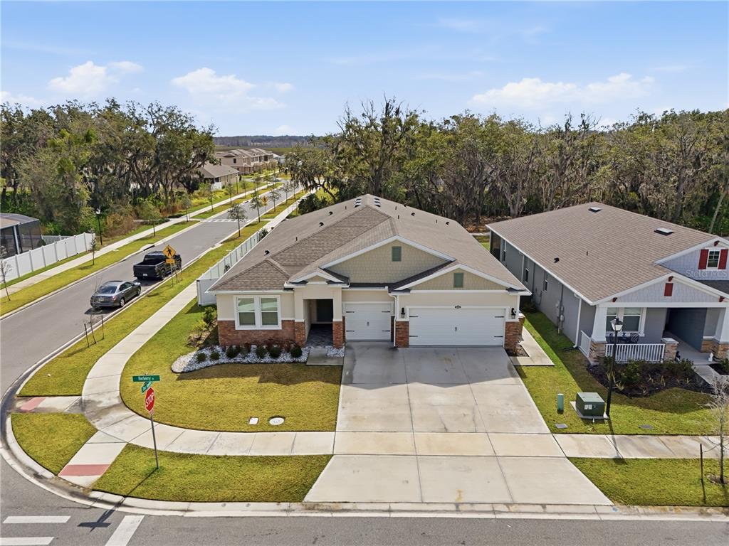An aerial view of a single-story suburban house with a two-car garage and driveway — 1636 BARBERRY DRIVE, KISSIMMEE, FL
