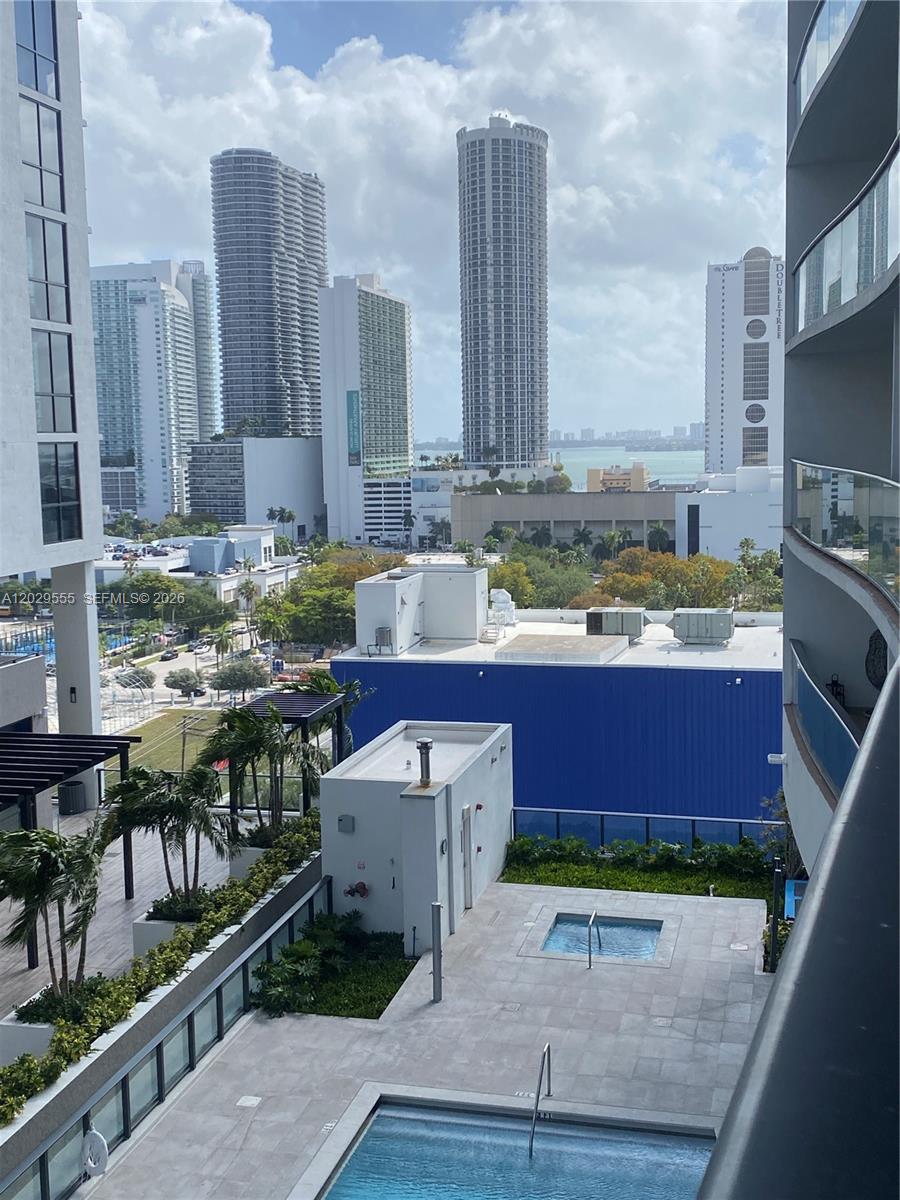 An elevated view of a swimming pool and hot tub overlooking a city skyline — 1600 NE 1st Ave # 1117, Miami FL 33132, MIAMI, FL