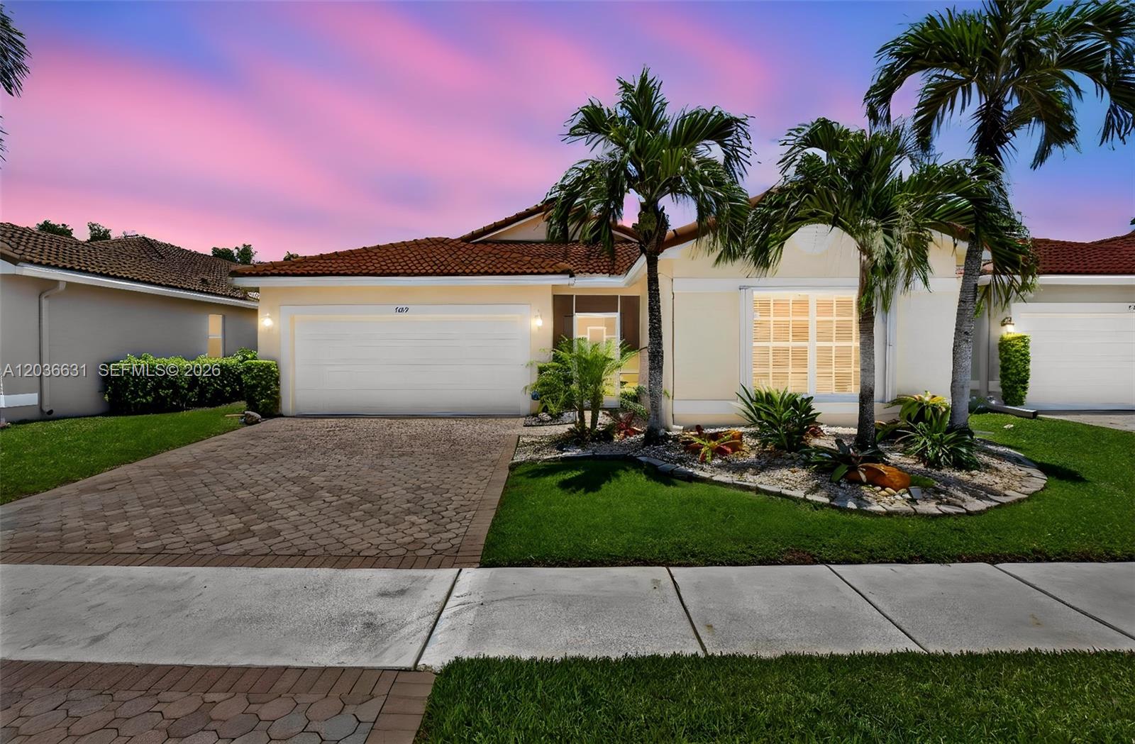 A single-story house with a paved driveway, palm trees, and a red tile roof — 7679 Lemonwood St, Boynton Beach FL 33437, BOYNTON BEACH, FL