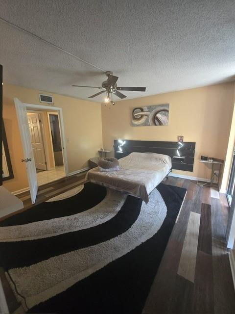A bedroom features a bed, a ceiling fan, and a large black and white rug — 5160 Las Verdes Circle # 217, Delray Beach FL 33484, DELRAY BEACH, FL
