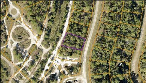 This is an aerial map showing a highlighted vacant residential lot among surrounding wooded properties — LANGLAIS DRIVE, NORTH PORT, FL
