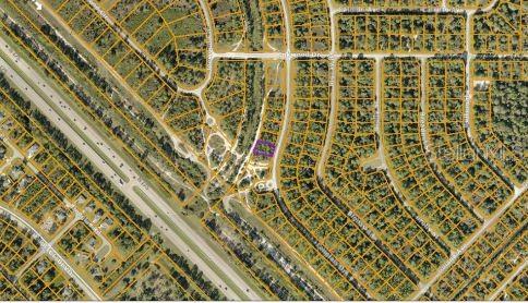 This is an aerial map view showing a highlighted residential lot within a suburban neighborhood — LANGLAIS DRIVE, NORTH PORT, FL