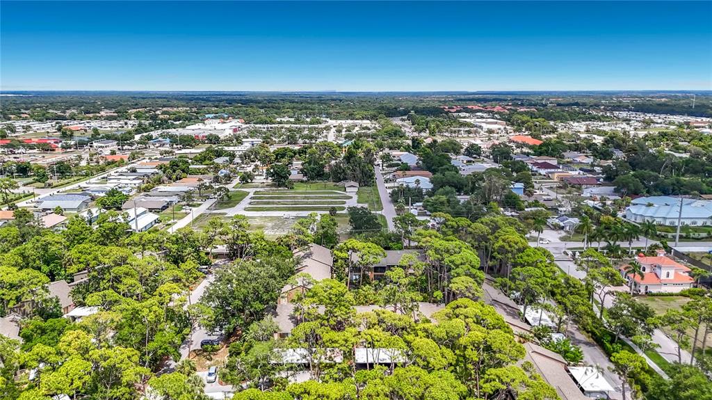 A covered parking area with mailboxes sits in front of multi-story residential buildings and trees — 1715 PELICAN COVE ROAD UNIT GL339, SARASOTA, FL