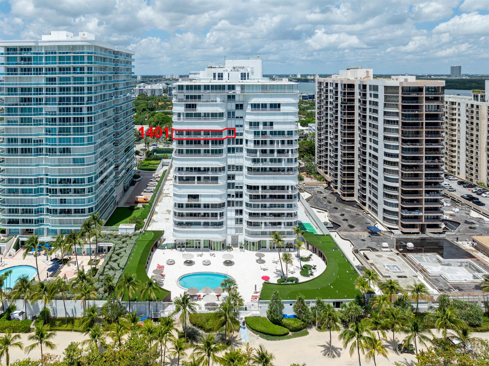 An aerial view shows three high-rise residential buildings with a pool area and beach access — 10155 Collins Avenue # 1401, Bal Harbour FL 33154, BAL HARBOUR, FL